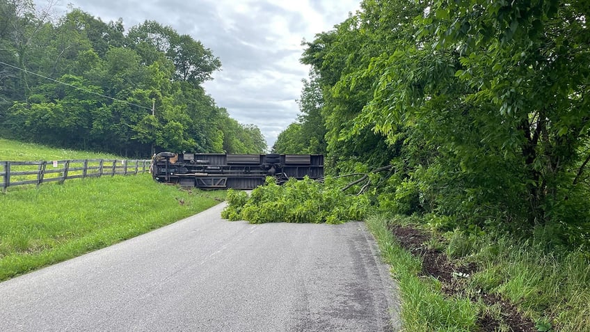 School bus on its side in the distance