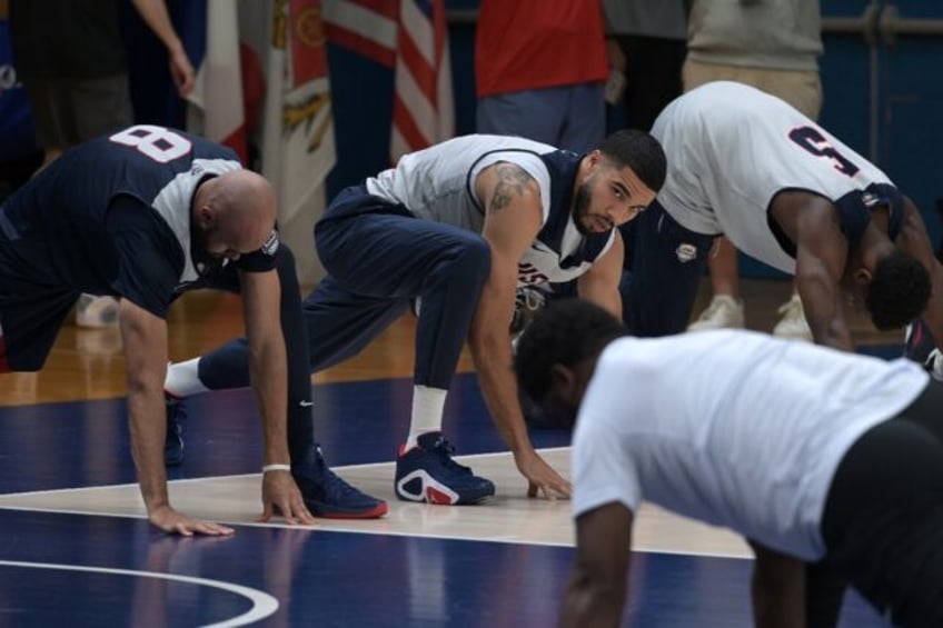 Boston star Jayson Tatum (centre) was left out of the USA's opening Olympic win over Serbi