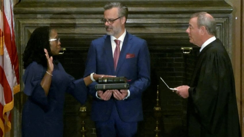 Supreme Court Justice Ketanji Brown Jackson takes an oath administered by Chief Justice John Roberts