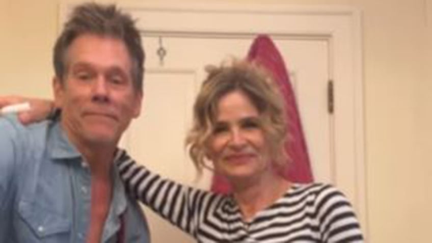 Kyra Sedgwick wraps her arm around husband Kevin Bacon.