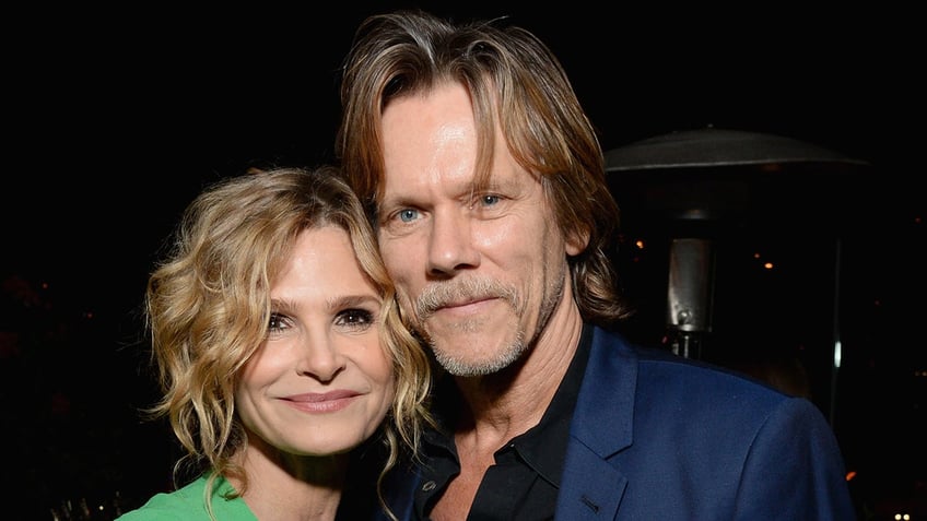 Kevin Bacon and Kyra Sedgwick embracing