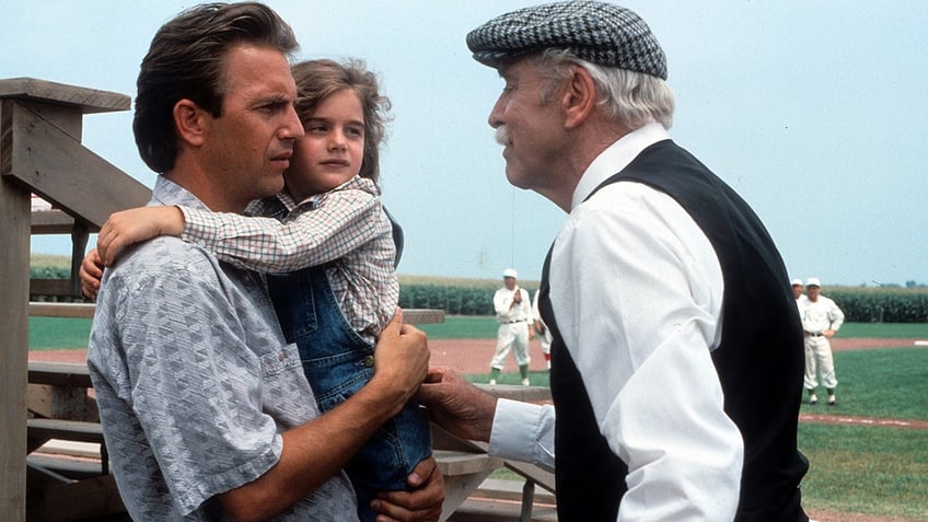 Kevin Costner holds Gabby Hoffman in Field of Dreams.