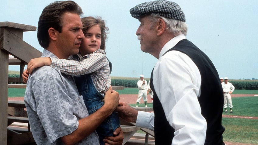 Kevin Costner holds Gabby Hoffman in Field of Dreams.