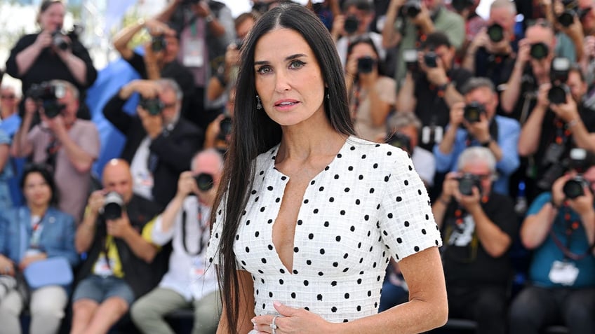 Demi Moore ain a white polka dot dress at Cannes