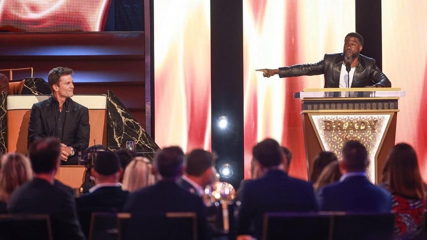 Kevin Hart on stage with Tom Brady