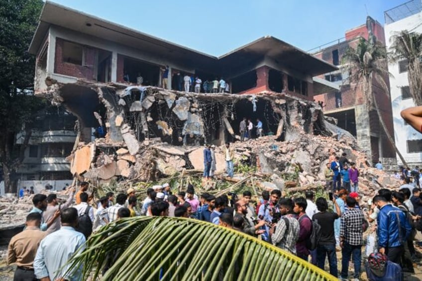 Protesters have smashed buildings connected to Sheikh Hasina's family using excavators --