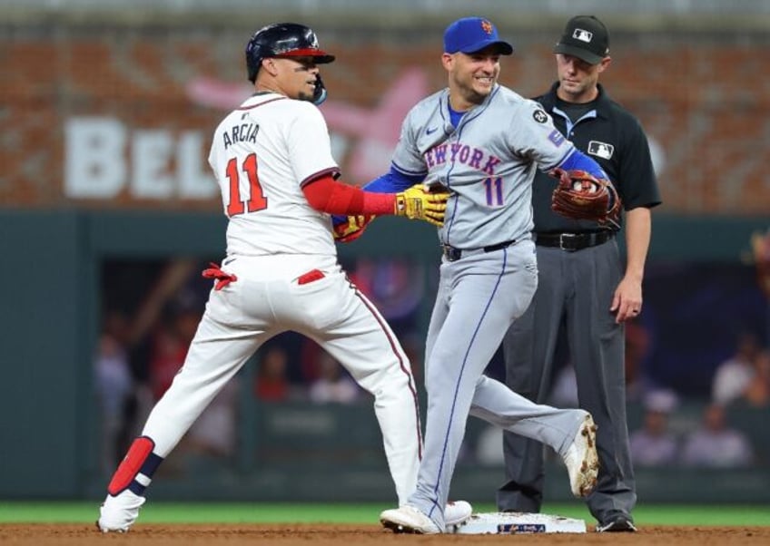 Atlanta's Orlando Arcia, left, and Jose Iglesias of the New York Mets must wait until Mond