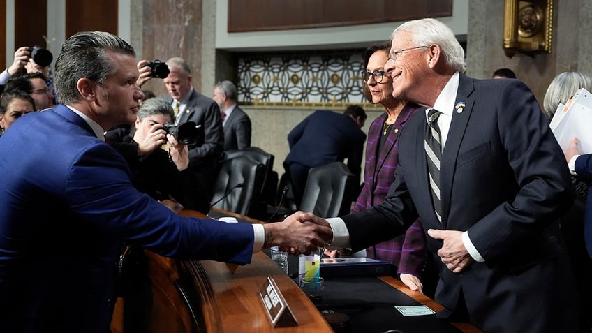 Pete Hegseth shaking hands with Chairman Roger Wicker