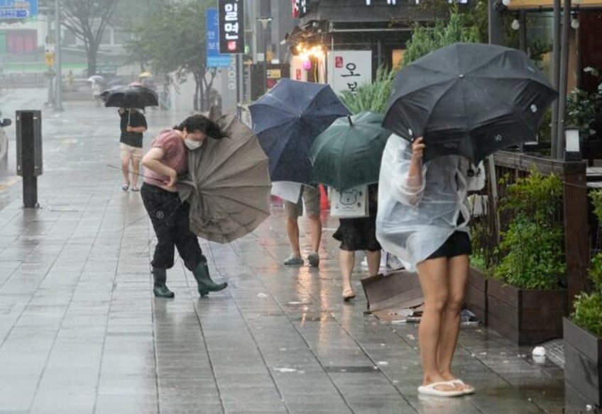 khanun blows strong winds and heavy rains into south korea where thousands evacuated the coast