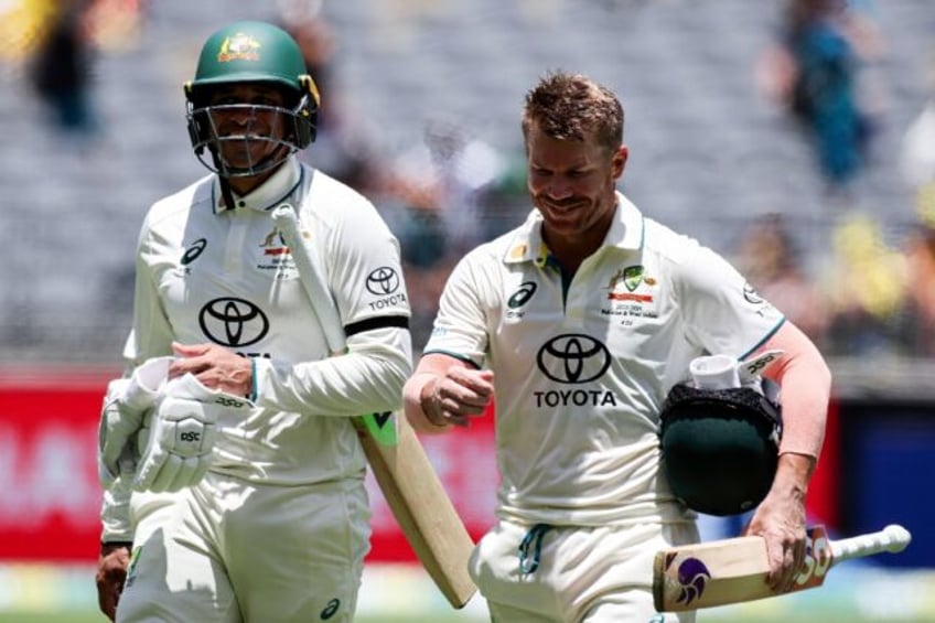 Australia’s Usman Khawaja (L) wearing a black armband during the first Test against Pakistan Perth