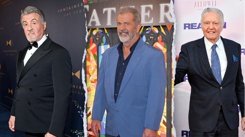 Sylvester Stallone in a black classic tuxedo looks serious as he looks directly at the camera on the carpet split Mel Gibson smiles in a blue suit and black shirt on the carpet split Jon Voight in a dark navy suit with a blue tie with American flags on it smiles on the carpet outstretching his hand