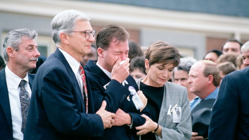 David Smith, father of the boys, leaves the church after funeral services for the two young boys.