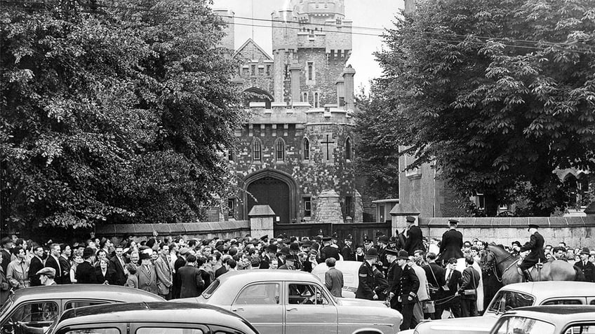 A crowd gathering outside a court room.