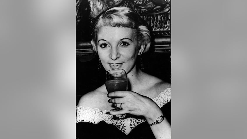 Ruth Ellis holding a glass.