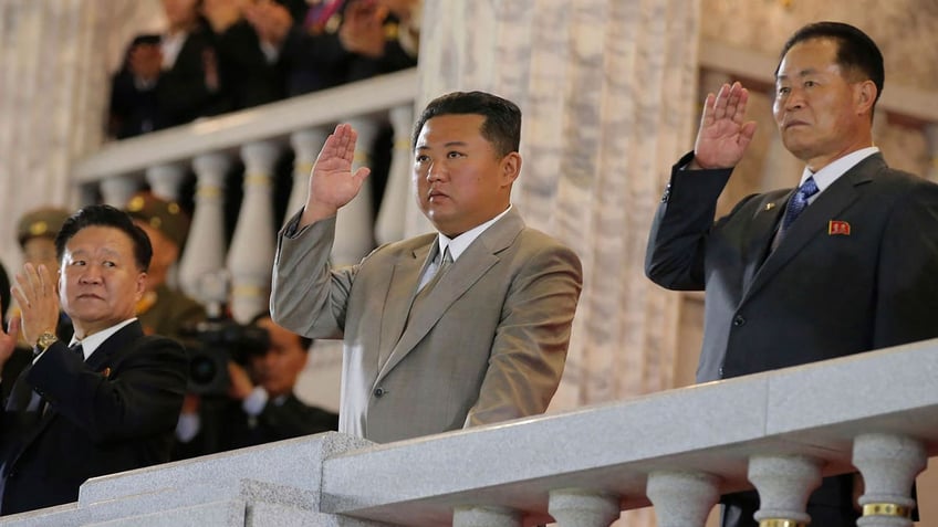 North Korean leader Kim Jong Un, center, waves from a balcony toward the assembled troops and spectators during a celebration of the nation’s 73rd anniversary at Kim Il Sung Square in Pyongyang, North Korea, on Thursday, Sept. 9, 2021.