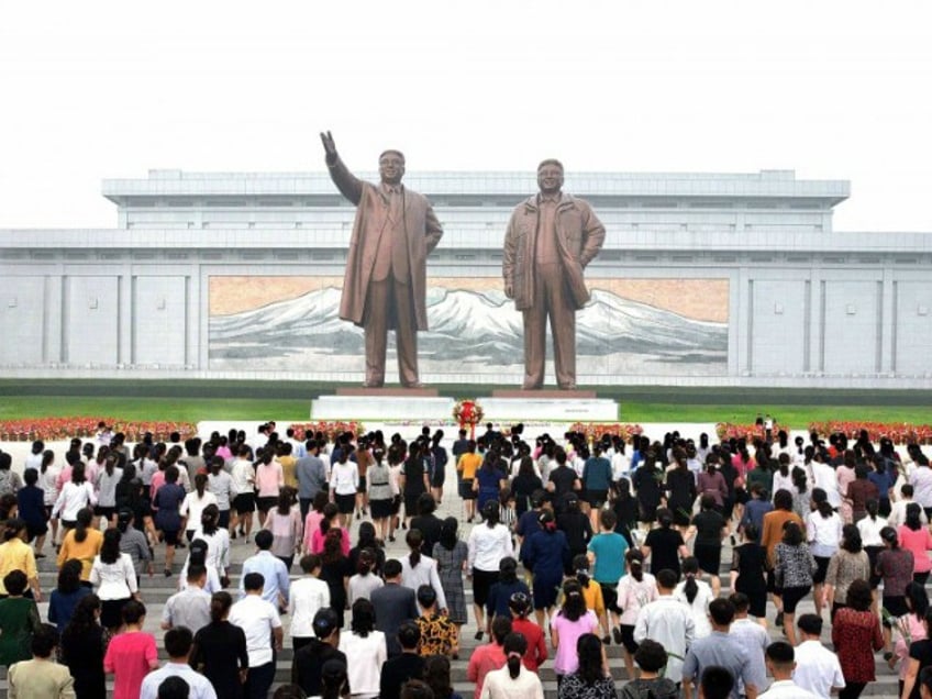 This picture taken and released from North Korea's official Korean Central News Agency (KCNA) on September 9, 2017 shows North Korean residents offering flowers before the statues of Kim Il-Sung and Kim Jong-Il (R) on Mansu Hill in Pyongyang during celebrations of the 69th anniversary of North Korea's national day. / AFP PHOTO / KCNA VIA KNS / KNS / South Korea OUT / REPUBLIC OF KOREA OUT ---EDITORS NOTE--- RESTRICTED TO EDITORIAL USE - MANDATORY CREDIT 'AFP PHOTO/KCNA VIA KNS' - NO MARKETING NO ADVERTISING CAMPAIGNS - DISTRIBUTED AS A SERVICE TO CLIENTS THIS PICTURE WAS MADE AVAILABLE BY A THIRD PARTY. AFP CAN NOT INDEPENDENTLY VERIFY THE AUTHENTICITY, LOCATION, DATE AND CONTENT OF THIS IMAGE. THIS PHOTO IS DISTRIBUTED EXACTLY AS RECEIVED BY AFP. / (Photo credit should read KNS/AFP/Getty Images)