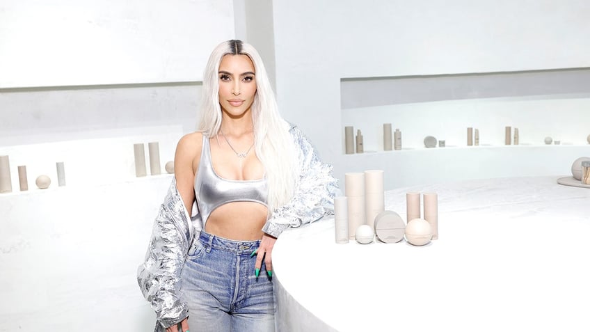 Kim Kardashian posing with Skkn products