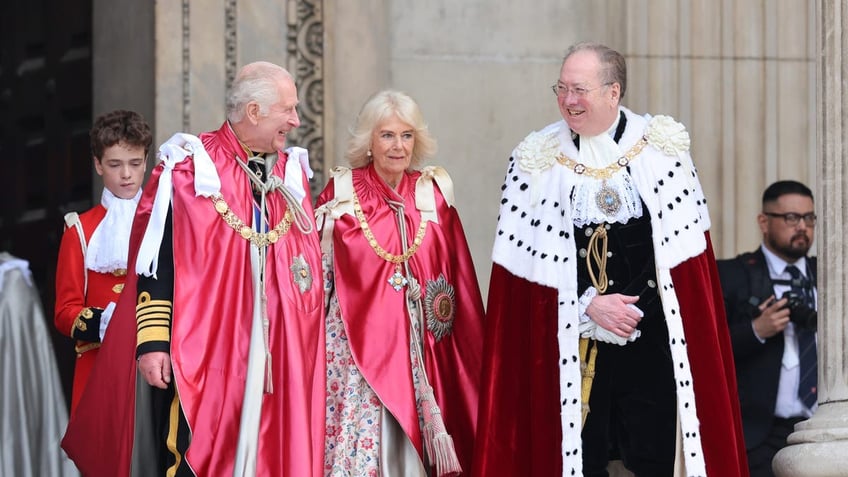 King Charles III shares a joke with Lord Mayor, Alderman Professor Michael Mainelli as he and Queen Camilla depart a service of dedication for the Order of The British Empire