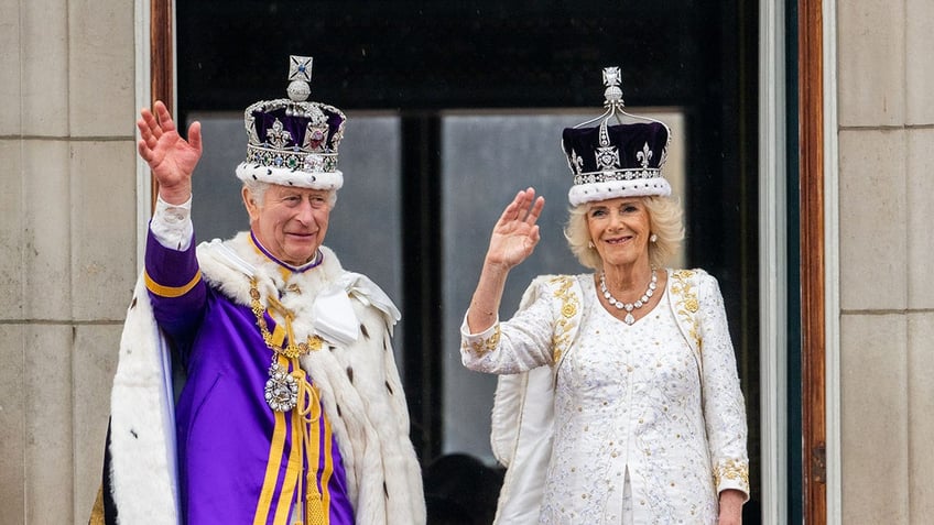 King Charles and Queen Camilla in royal regalia on the balcony of Buckingham Palace