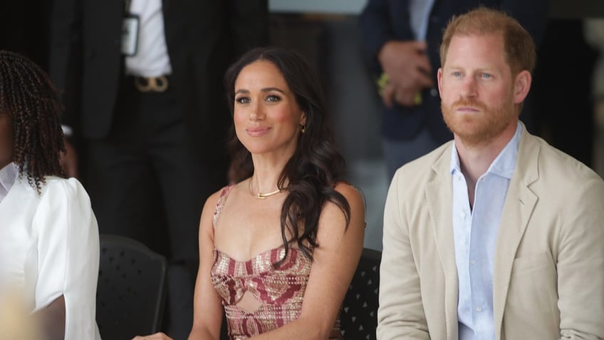 Prince Harry and Meghan Markle sitting together.