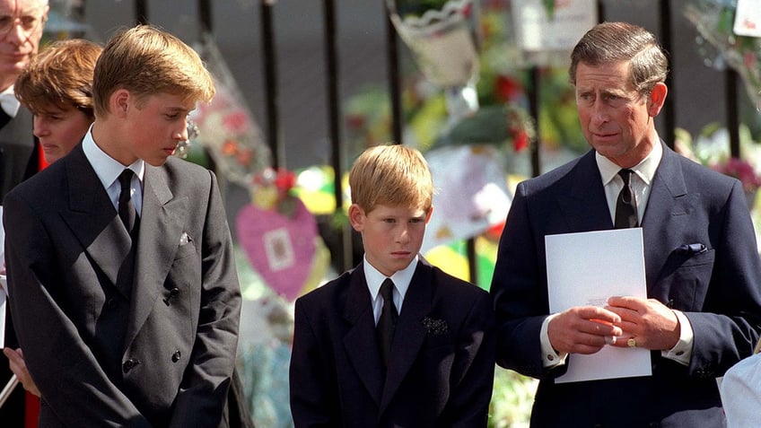 Prince William, Prince Harry and Prince Charles looking downcast at Princess Dianas funeral