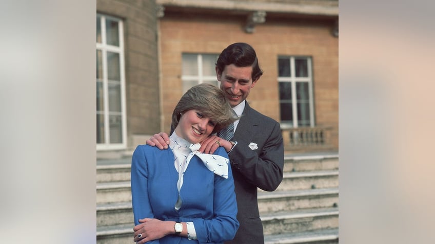 Prince Charles rubbing Princess Dianas shoulders after announcing their engagement.