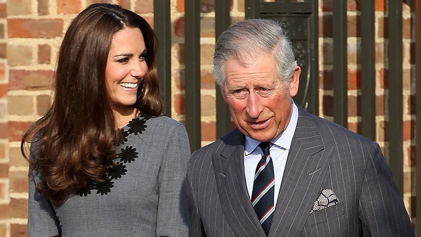 Kate Middleton and King Charles smiling and standing side by side
