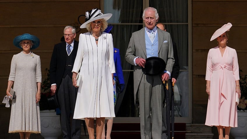 The royals standing together in formal wear