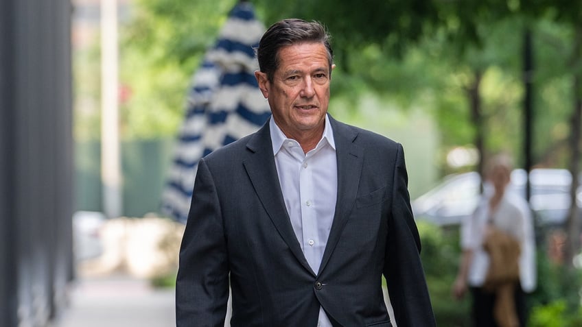 Jes Staley in a grey blazer and an open button white shirt.