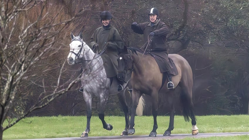 Prince Andrew on horseback with a companion alongside him.