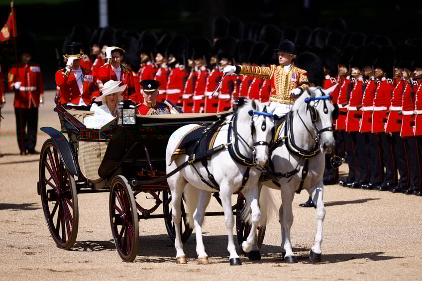 Britain's King Charles III and Britain's Queen Camilla arrive to Horse Guards Parade during the King's Birthday Parade, "Trooping the Colour", in London on June 14, 2025. The ceremony of Trooping the Colour is believed to have first been performed during the reign of King Charles II. Since 1748, the Trooping of the Colour has marked the official birthday of the British Sovereign. Over 1500 parading soldiers and almost 300 horses take part in the event. (Photo by BENJAMIN CREMEL / AFP) (Photo by BENJAMIN CREMEL/AFP via Getty Images)