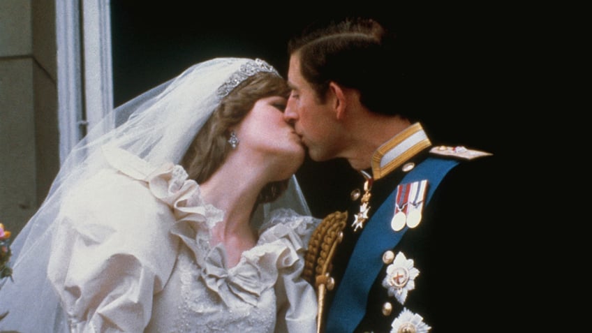 Prince Charles and Princess Diana kissing on their wedding day.