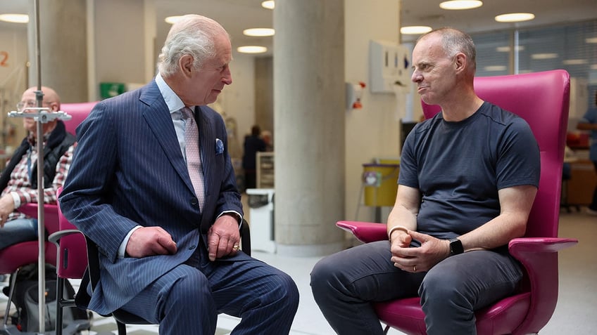 King Charles sitting down and chatting with a cancer patient