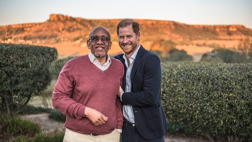 Prince Harry holding onto the arm of Prince Seeiso of Lesotho