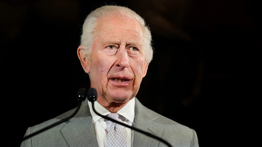 A close-up of King Charles speaking in front of a podium.