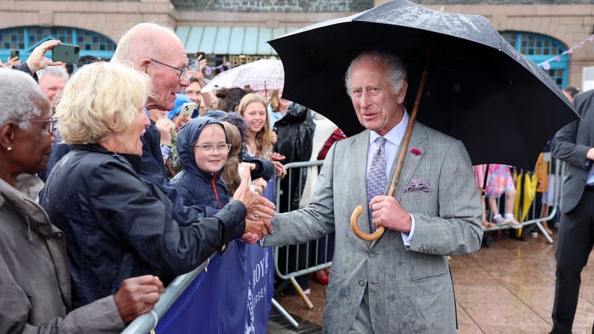 A photo of King Charles meeting with fans