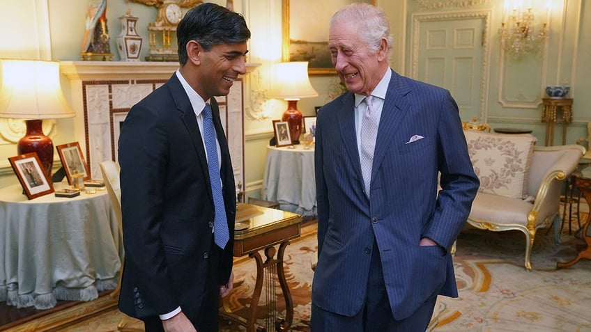 King Charles and Prime Minister Rishi Sunak laugh at Buckingham Palace