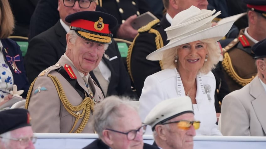King Charles and Queen Camilla smile