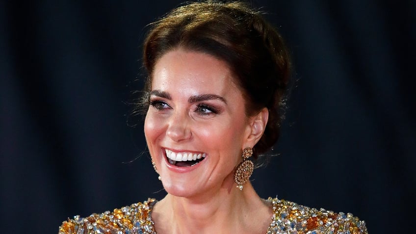 A close-up of Kate Middleton wearing a sparkling gold dress.