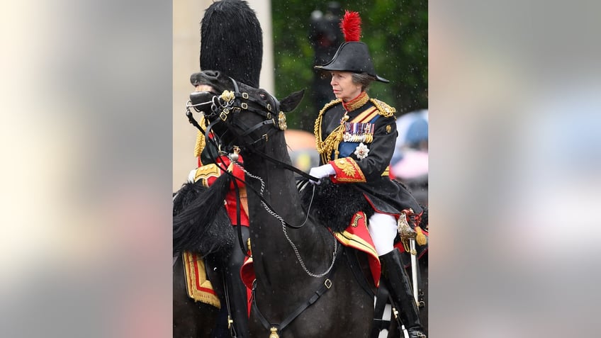 Princess Anne in uniform riding a horse.