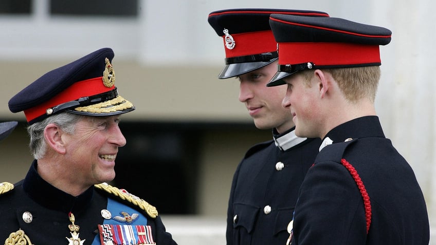 King Charles admiring his sons as they all three wear matching uniforms