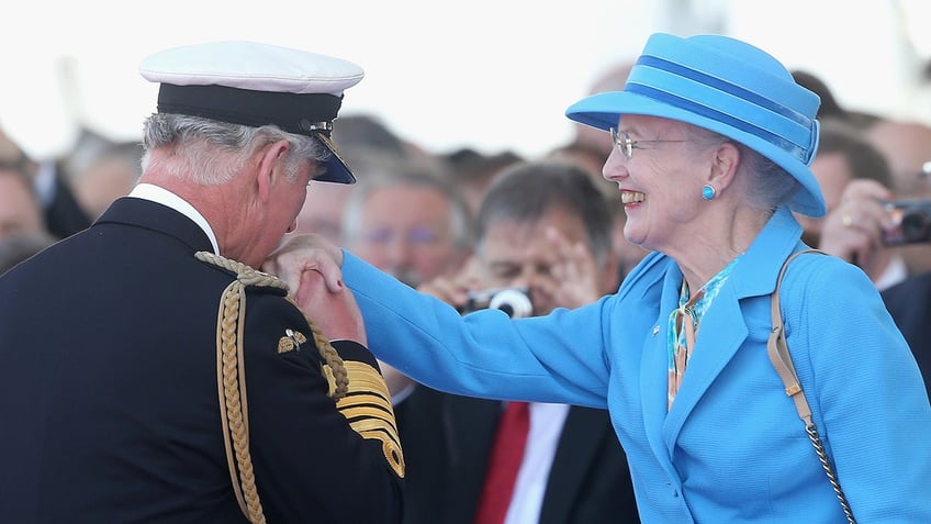 King Charles kissing Queen Margrethes hand