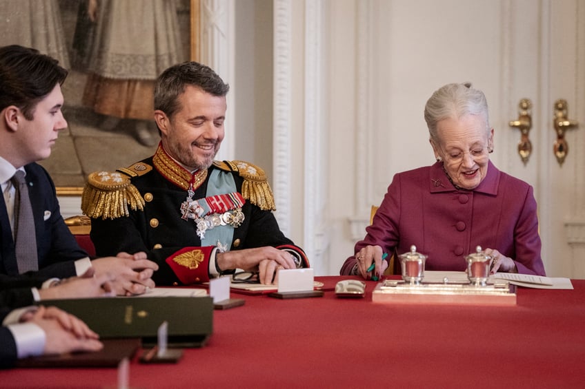 Queen Margrethe II of Denmark (R) signs a declaration of abdication as Crown Prince Frederik of Denmark becomes King Frederik X of Denmark (C) and Prince Christian of Denmark react in the Council of State at the Christiansborg Castle in Copenhagen, Denmark, on January 14, 2024. Denmark turns a page in its history on January 14 when Queen Margrethe abdicates and her son becomes King Frederik X, with more than 100,000 Danes expected to turn out for the unprecedented event. The change of throne takes place during the meeting of the Council of State at the moment when the queen has signed a declaration of abdication. (Photo by Mads Claus Rasmussen / Ritzau Scanpix / AFP) / Denmark OUT (Photo by MADS CLAUS RASMUSSEN/Ritzau Scanpix/AFP via Getty Images)