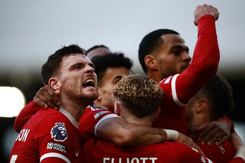 Andy Robertson (left) leads the celebrations after Liverpool's third goal