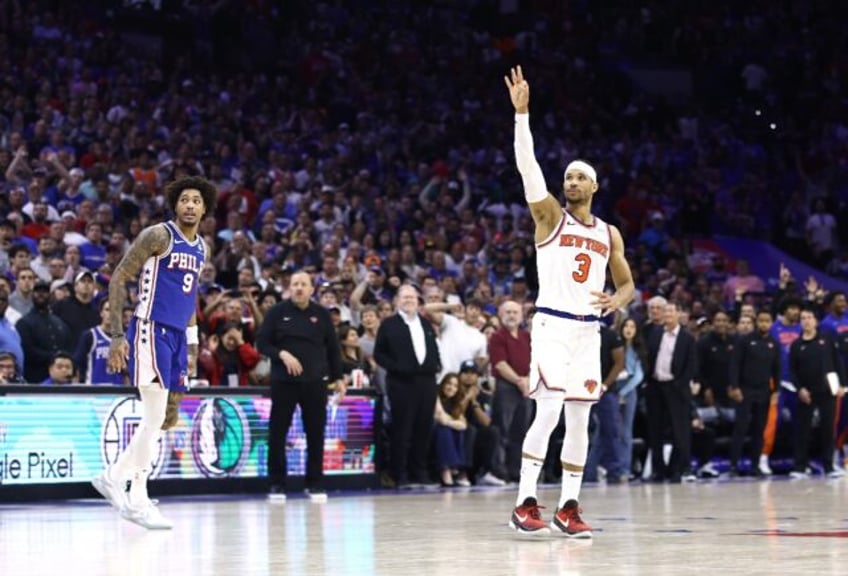 New York's Josh Hart celebrates his late three-pointer as Philadelphia's Kelly Oubre looks