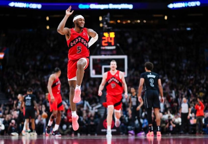 Immanuel Quickley of the Toronto Raptors celebrates a three-point basket in an NBA victory