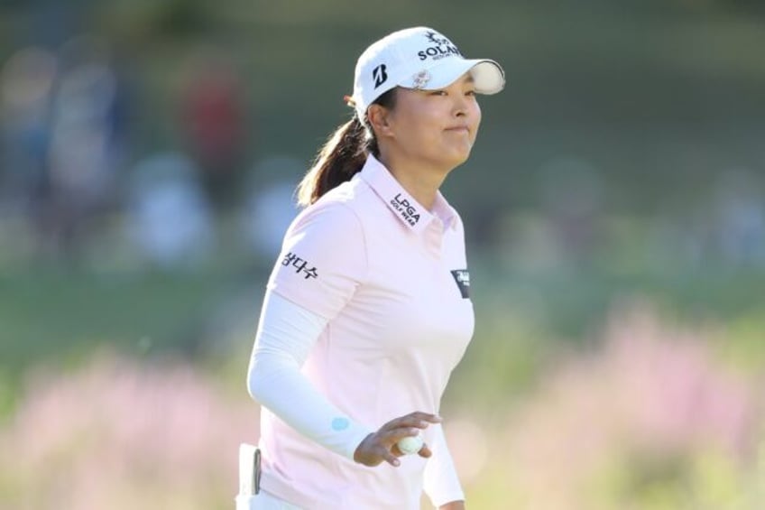 Leader Ko Jin-young of South Korea acknowledges the crowd on the 18th green during the thi