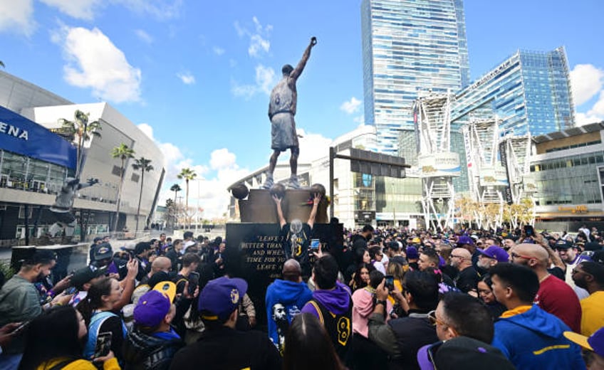 Fans gather around the newly unveiled Kobe Bryant statue outside the Crypto.com Arena on February 9, 2024 in Los Angeles. The 19-foot bronze statue,...