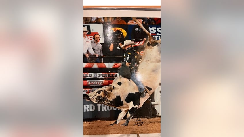 Kody Lostroh, professional bull rider, riding a bull 