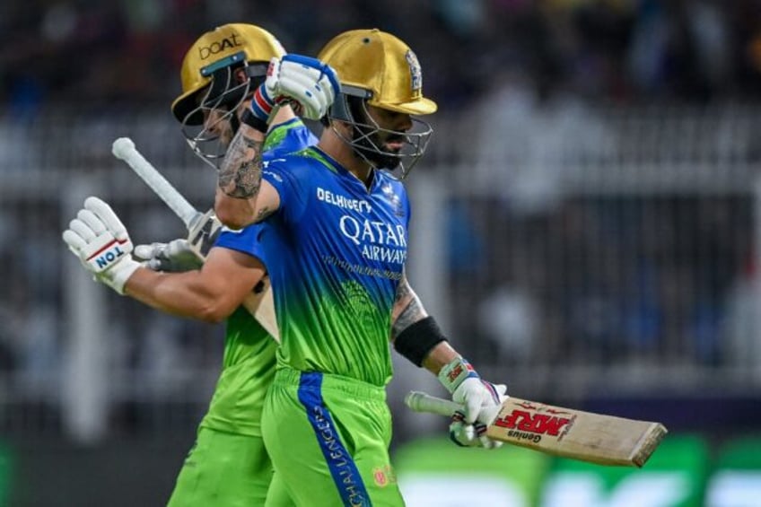 Angry: Virat Kohli (R) walks back to the pavilion after his controversial dismissal